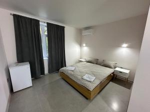 a small bedroom with a bed and a window at Casa Blanca in Vadul lui Vodă +18 photos