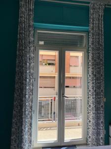 a door with a window in a room at Dream Guest House in Pisa