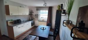a small kitchen with a table and a dining room at Ferienwohnung Fichtelgebirge in Brand