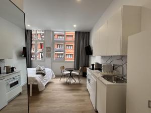 a kitchen with a sink and a bed in a room at Gabika Apartment 1 in Bilbao +8 photos