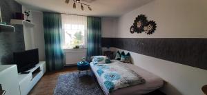 a small bedroom with a bed and a television at Ferienwohnung Fichtelgebirge in Brand
