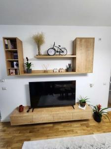 a living room with a flat screen tv in a living room at Luxury & Green Apartments Modern Stay with Private Terrace in Pristina