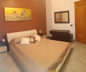 a bedroom with a large bed and a piano at Appartamento vista mare in Castellammare del Golfo