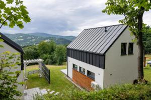 a small house with a black and white facade at Zawoja House in Zawoja