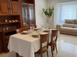 a dining room table with a white table cloth and chairs at Apartament Rural ca la Roser in Espluga de Francolí +41 photos