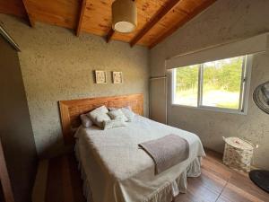 a bedroom with a bed in a room with a window at Complejo de cabañas Vida Paz in Las Calles +46 photos