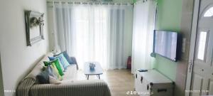 a living room with a couch and a tv at Leodi Place in Kipséli
