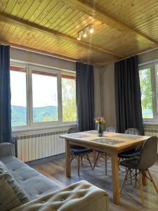 a living room with a table and a couch at Vista Krasiya in Vyshka