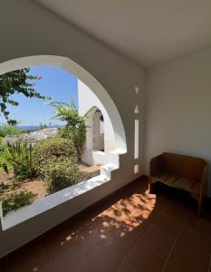 a room with an arched window and a couch at Domina Coral Bay Private Studios - Oasis - Blocco 34 in Sharm El Sheikh