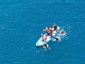a group of people on a raft in the water at Mucobega Hotel in Sarandë