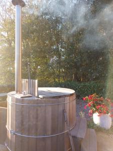 a hot tub with smoke coming out of it at TIPI de LOUIS in Sarlande +5 photos
