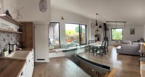 a kitchen and living room with a table and chairs at Soví Hnízdo Apartment De Luxe in Rudník