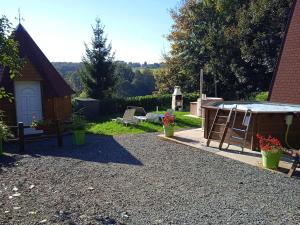 a backyard with a hot tub and a shed at TIPI de LOUIS in Sarlande