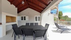 a dining room with a table and chairs on a patio at Villa Bell'Aria Korcula in Vela Luka