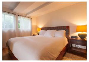 a bedroom with a large white bed and a window at Casa Morada in Islamorada