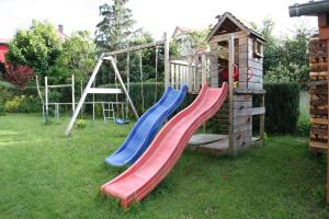 a playground with a slide and a play house at Ferienwohnung Hornig in Friedrichroda