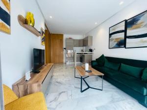 a living room with a green couch and a table at NOCI Luxury living in Casablanca