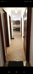 a hallway of a room with doors and a tile floor at Résidence de luxe cabo dream 2 chambre salon in Cabo Negro