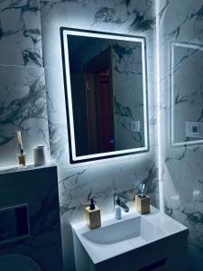 a bathroom with a white sink and a mirror at Davos in Zlatibor +16 photos