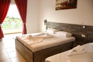 Postel nebo postele na pokoji v ubytování Mucobega Hotel 2
