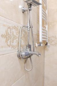 a shower head on a wall in a bathroom at SkyView Luxe City View Apartment Saakadze Square in Tbilisi City +21 photos
