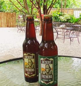two bottles of beer sitting on a table at The Weekend Farmer in Alfonso
