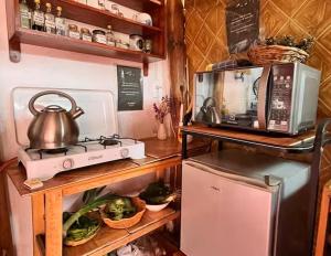 a kitchen with a microwave and a toaster oven at La Huerta Refugio in Urubamba