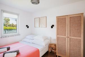 a small bedroom with a bed and a window at My Slow Stay Łeba in Szczenurze +58 photos