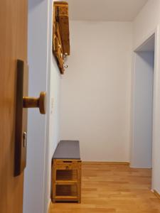 a room with an open door with a suitcase on the wall at Stilvolles City-Apartment in Halle an der Saale