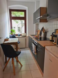a kitchen with a small table and a tableablish at Stilvolles City-Apartment in Halle an der Saale
