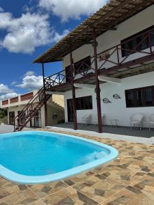 a large swimming pool in front of a building at Pousada Vista Gamboa in Camocim
