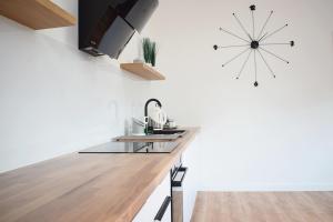 a kitchen with a sink and a clock on the wall at Duży dom rodzinny Ferencówka 506-747-773 in Zawóz +9 photos