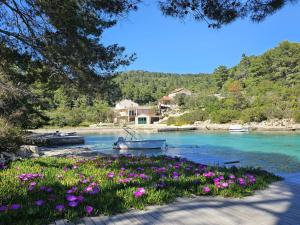 a group of boats on a river with flowers at Villa Bell'Aria Korcula in Vela Luka
