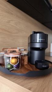 a coffee maker and a camera on a table at M&W Apartment in Uniejow