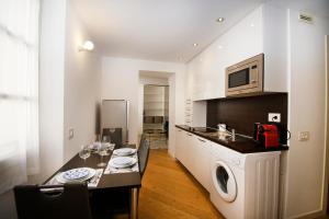 a kitchen with a table and a microwave at Princes Victoria Standing Presta in Cannes