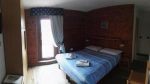 Postel nebo postele na pokoji v ubytování Rifugio Orso Bruno