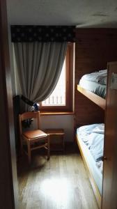 Postel nebo postele na pokoji v ubytování Rifugio Orso Bruno