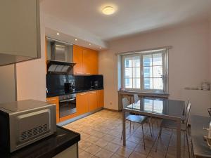 a kitchen with a table and a dining room at Beautiful private room - In a family home where 2 people live in a prime area of Luxembourg in Luxembourg