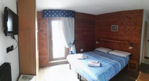 Postel nebo postele na pokoji v ubytování Rifugio Orso Bruno
