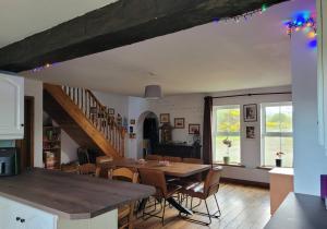 a kitchen and dining room with a table and chairs at The Portsalon House in Cloghfin