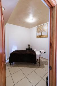 a bedroom with a bed and a table in a room at Hotel & Balneario Los Angeles in Taxco de Alarcón