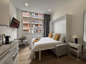 a bedroom with a bed and a large window at Gabika Apartment 4 in Bilbao