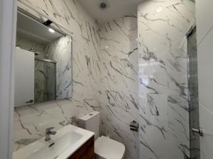 a bathroom with a sink and a toilet and a mirror at Gabika Apartment 4 in Bilbao