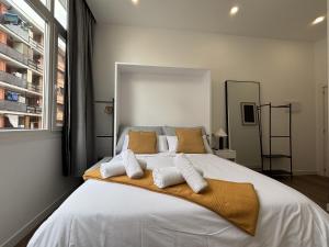a bedroom with a large white bed with two pillows at Gabika Apartment 4 in Bilbao +11 photos