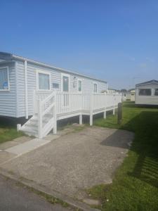 a mobile home with a porch and a deck at Caravan to Hire - CalaGran Fleetwood Blackpool in Fleetwood