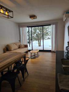 a living room with a couch and a table at Wenuk Patagonia in San Carlos de Bariloche