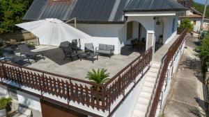 an outdoor patio with chairs and an umbrella on a house at Villa Attilio in Balsorano Vecchio