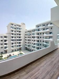 a view of two apartment buildings from a balcony at Duplex Luxe 3 Chambres Vue Mer & Piscine à Zenata Eco City in Aïn Harrouda
