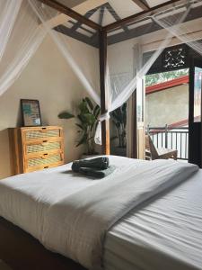 a bedroom with a large white bed and a window at Bakamuna Villa in Dickwella
