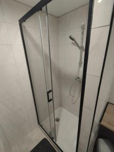 a shower with a glass door in a bathroom at Maison au calme L'échappée Tarnaise in Cunac +7 photos